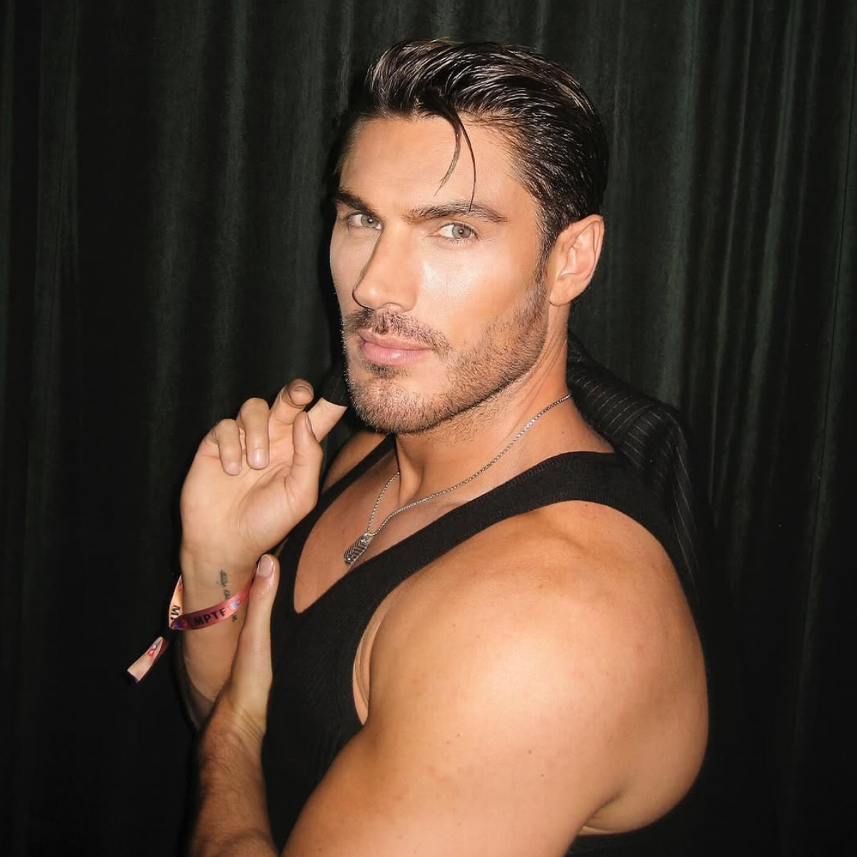 Chris Appleton with dark, slicked-back hair before his blonde transformation.
