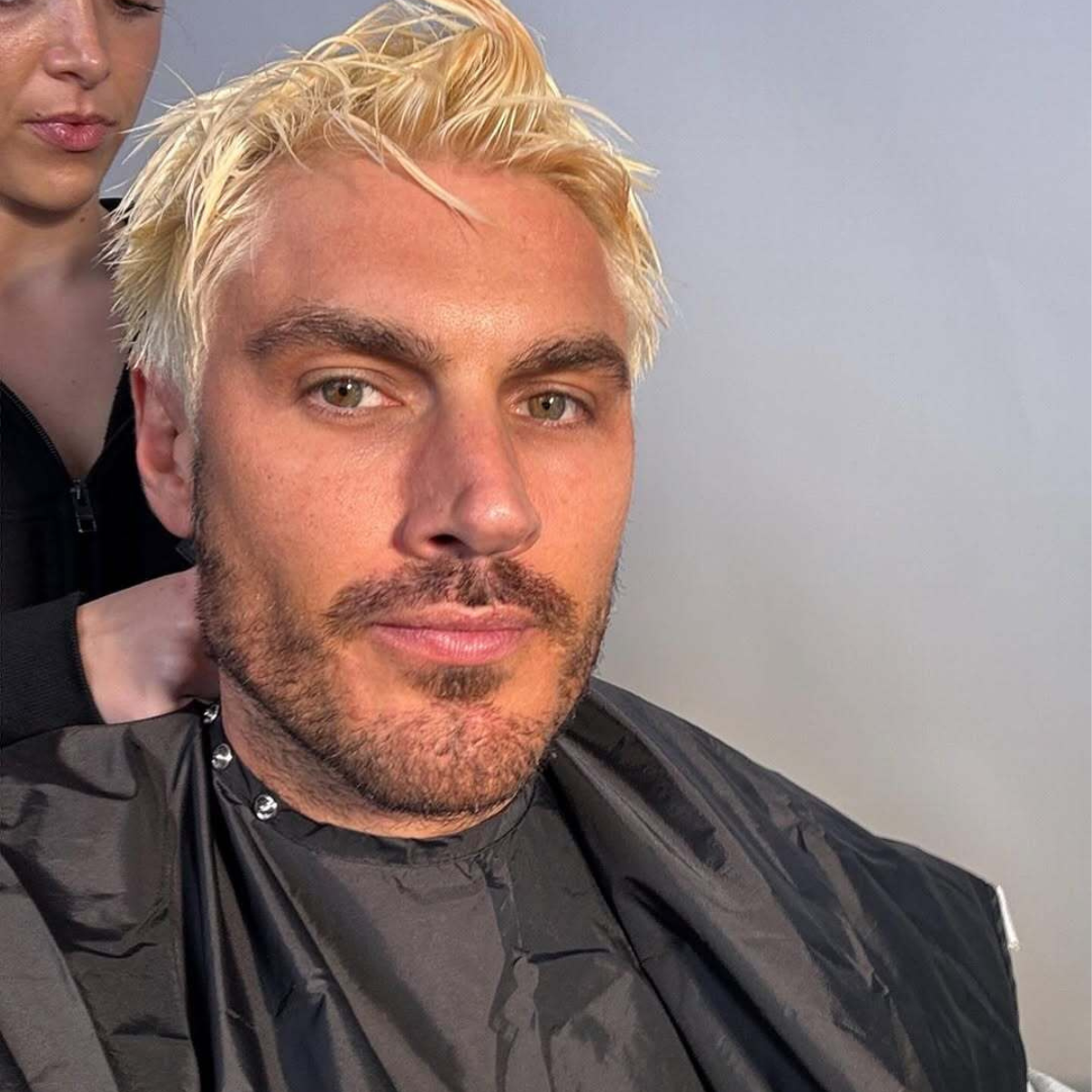 Chris Appleton mid-transformation with bleach processing on his hair in the salon.