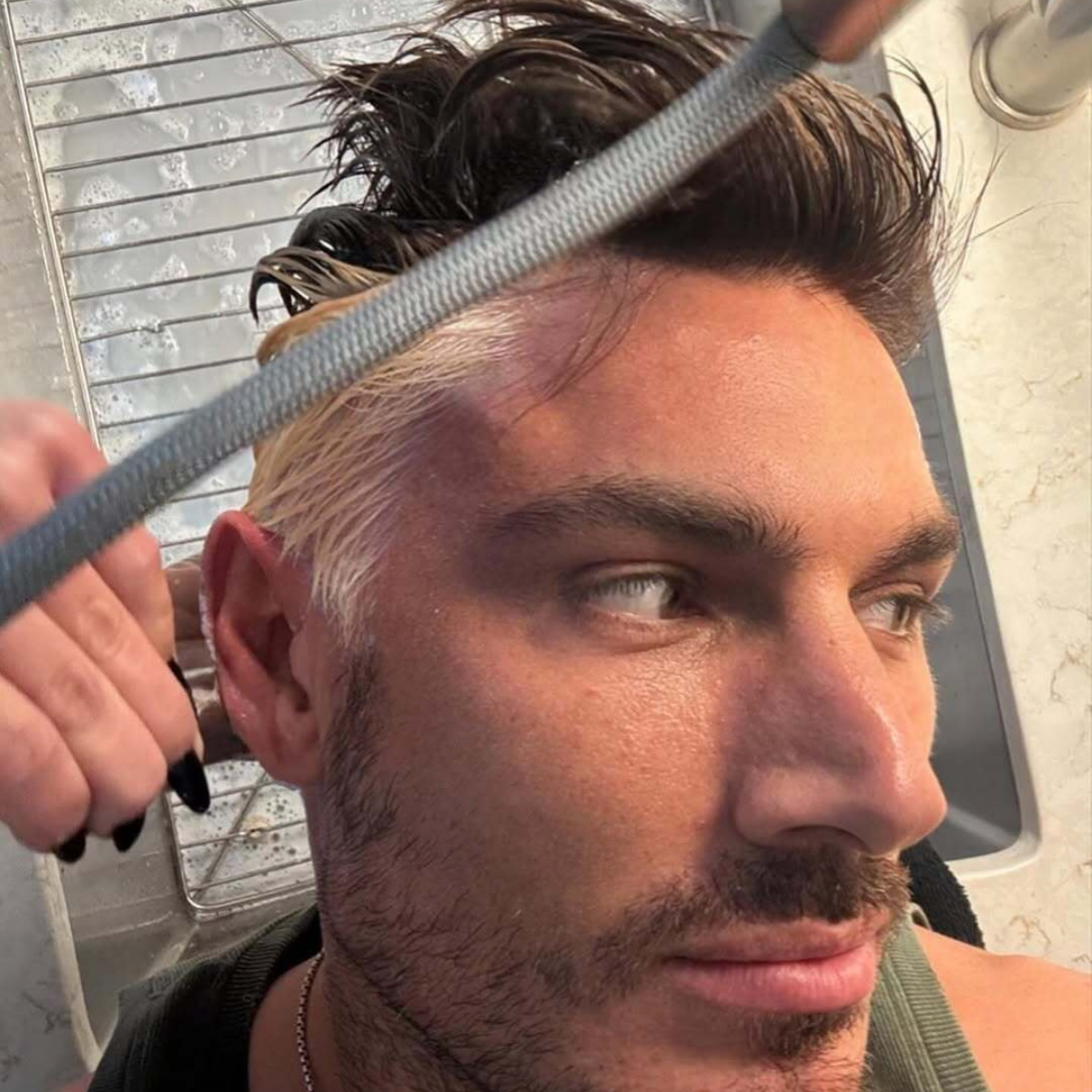A close-up of Chris Appleton getting his hair bleached, focusing on the application process.