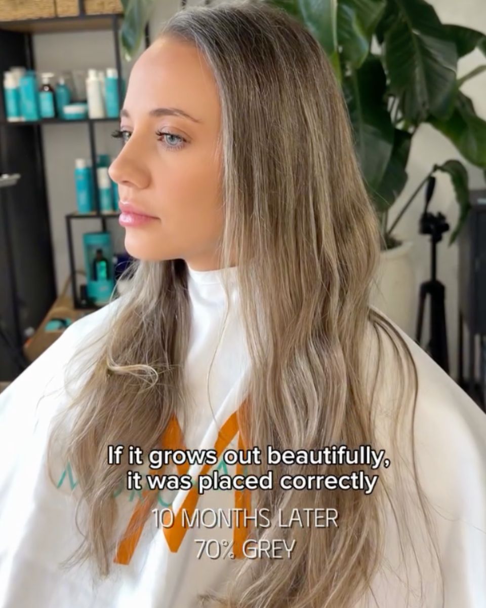 10-month grow-out showing natural grey blending with soft beige blonde dimension.