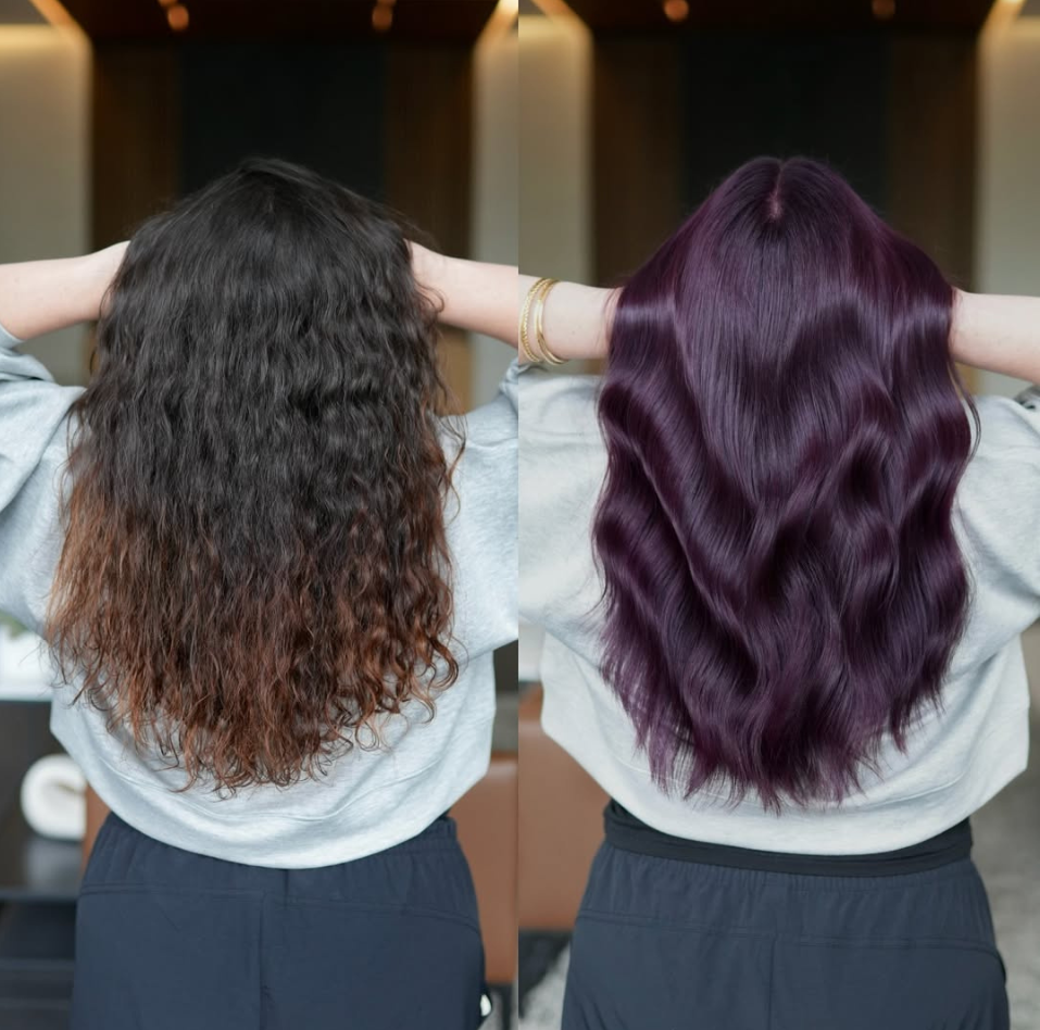 Back view of a hair transformation showing dark, curly brunette hair before and smooth, shiny plum-purple waves after.
